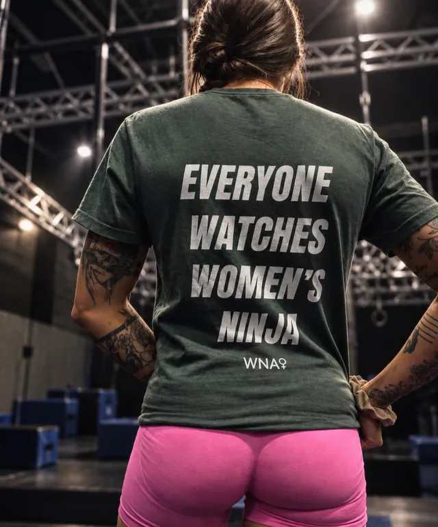 An athlete from behind in a green Everyone Watches Women's Ninja shirt