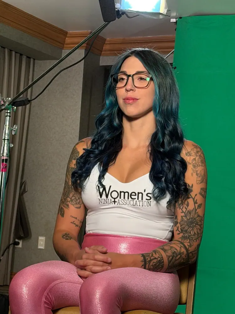 Megan Budway in a Women's Ninja Association tank top, seated for an interview
