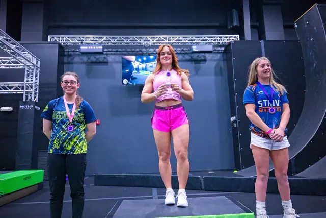 Three athletes on the podium with their medals