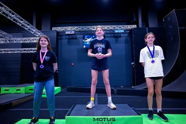 Three young athletes on the podium with their medals